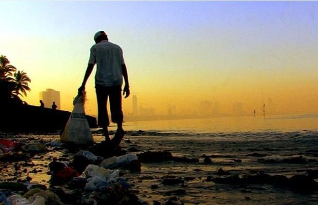 boy looks for recyclable materials