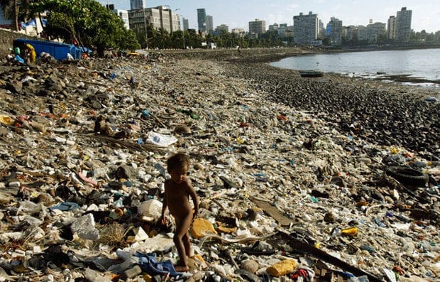 Child walks through waste on Mumbai Beach